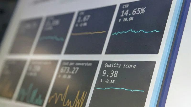 Close-up of a digital screen displaying performance metrics and graphs including CTR and quality score.