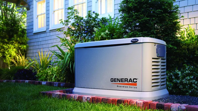 Generac Guardian Series generator in a lush garden setting, highlighting outdoor power solutions.