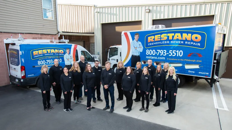 a group of people posing for a photo in front of a truck