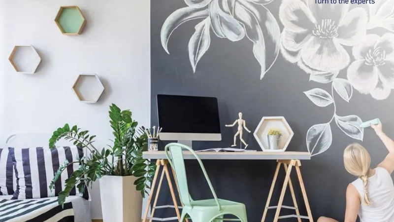 a person sitting on a chair in a room with a desk and a computer