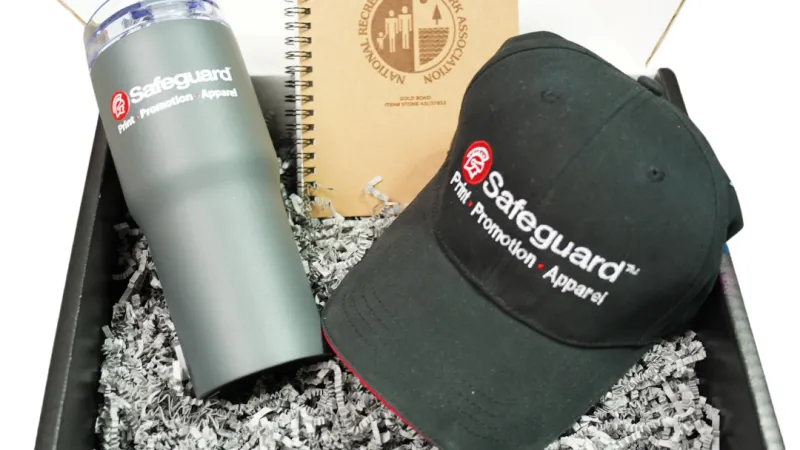 Gift box with Safeguard branded black cap, gray tumbler, and National Recreation and Park Association notebook.