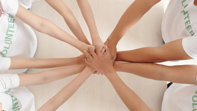 a group of people holding hands