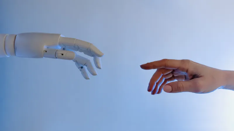 a hand holding a white object