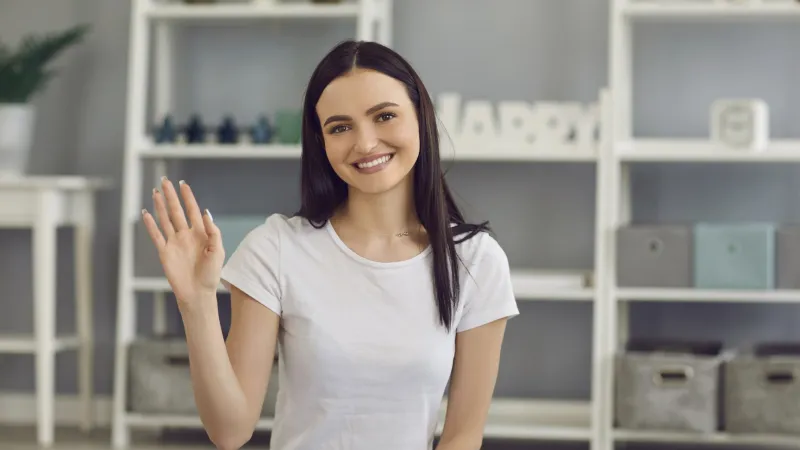 a woman with her hand up
