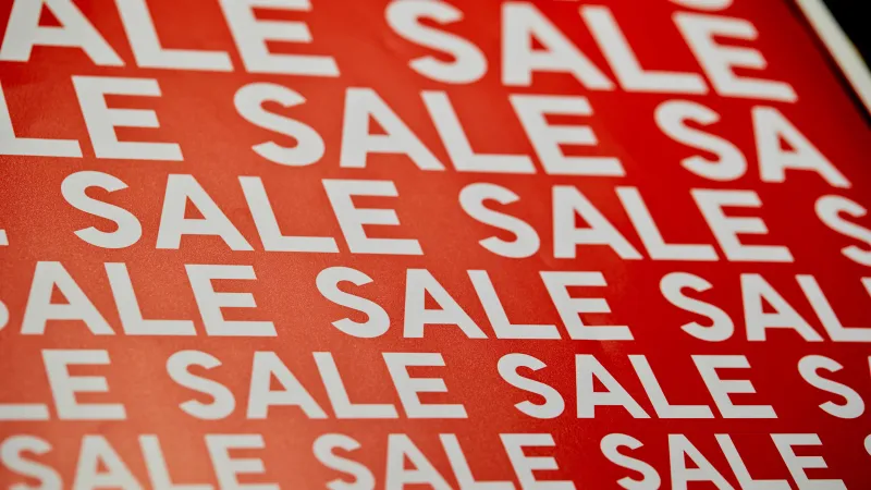 Red background with repeated white SALE text pattern for discount promotion