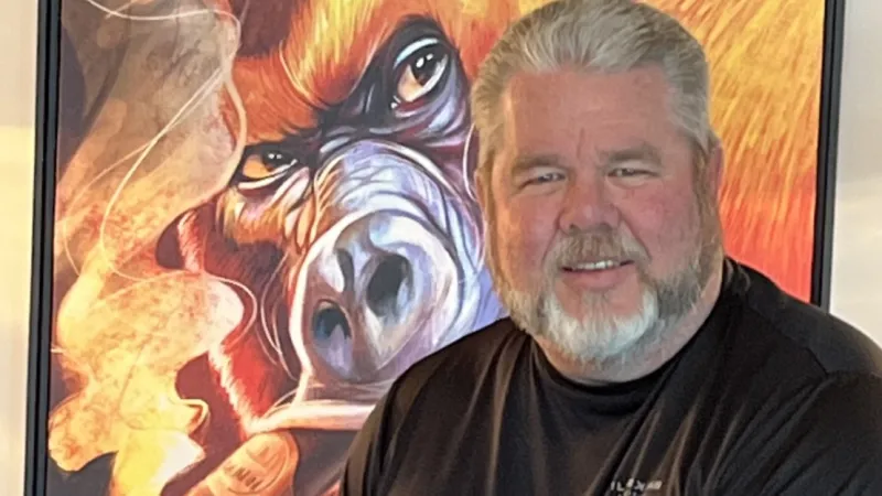 a man standing in front of a painting