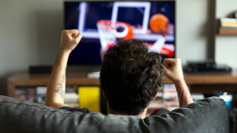 a man watching a television