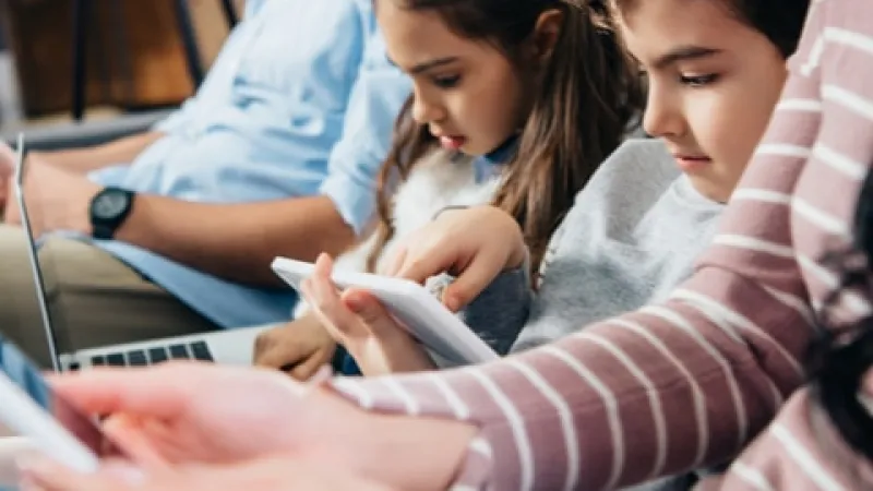 a group of people looking at a tablet