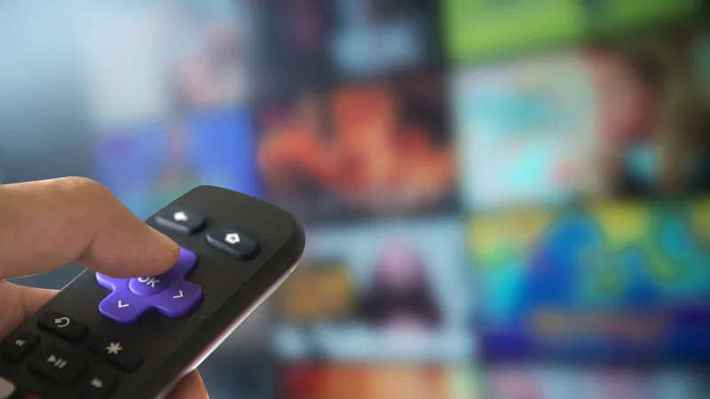 a person holds a remote control