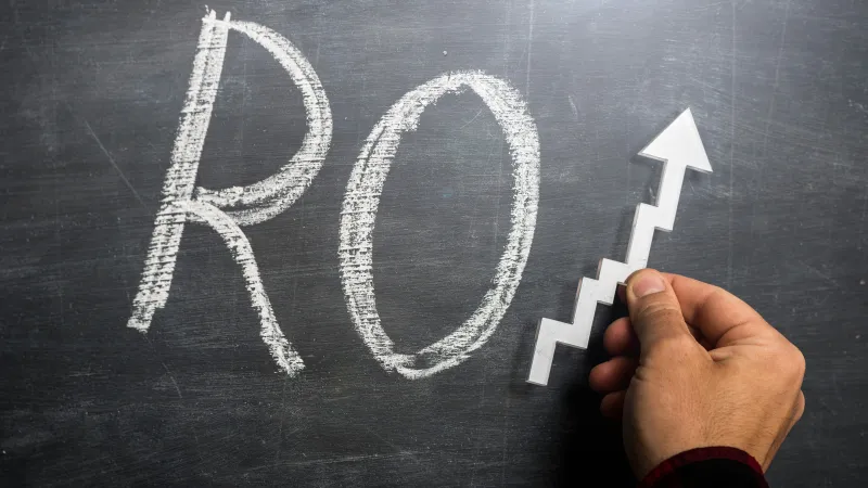 a hand writing on a chalkboard