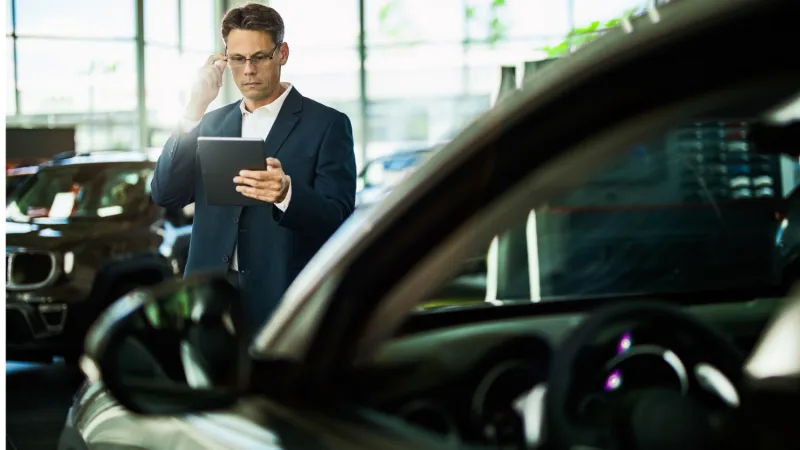 a person standing next to a car
