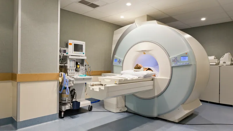 A patient undergoing an MRI scan in a modern medical facility with advanced equipment.