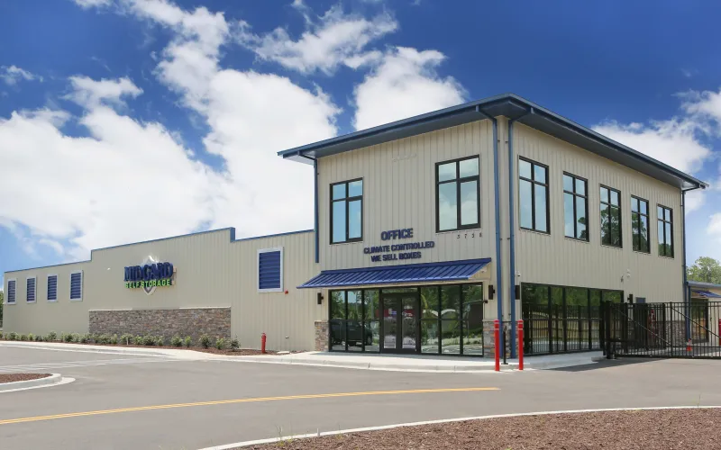 a house that has a sign on the side of a road