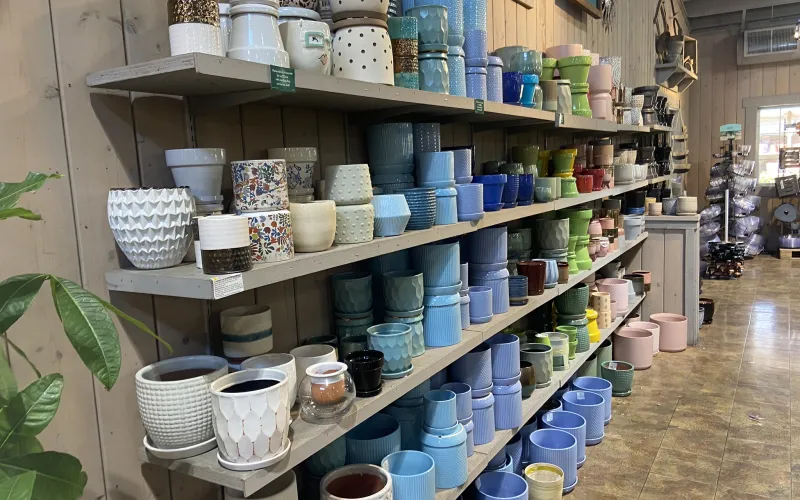 a room with shelves of pots and pans