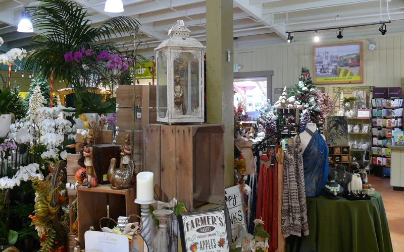 a room filled with furniture and vase of flowers on a table