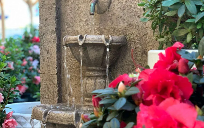 a vase of flowers on a brick building