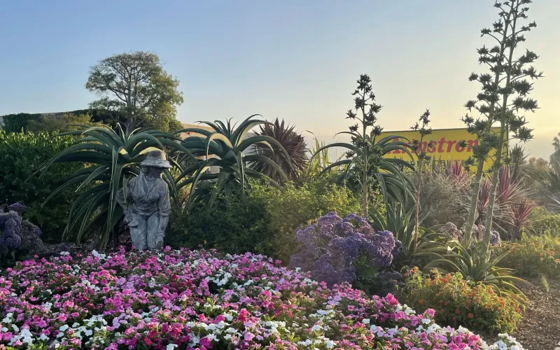 Armstrong Torrance landscape with statue and vinca flowers