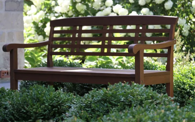 a wooden bench in a garden