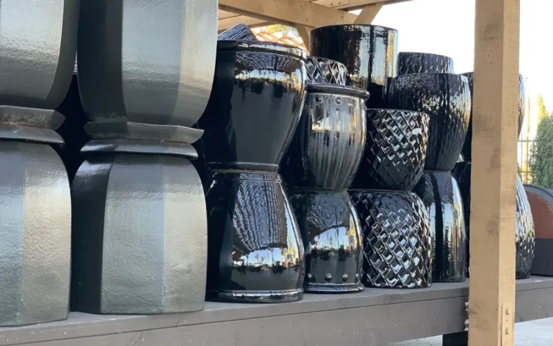 a shelf with metallic planters