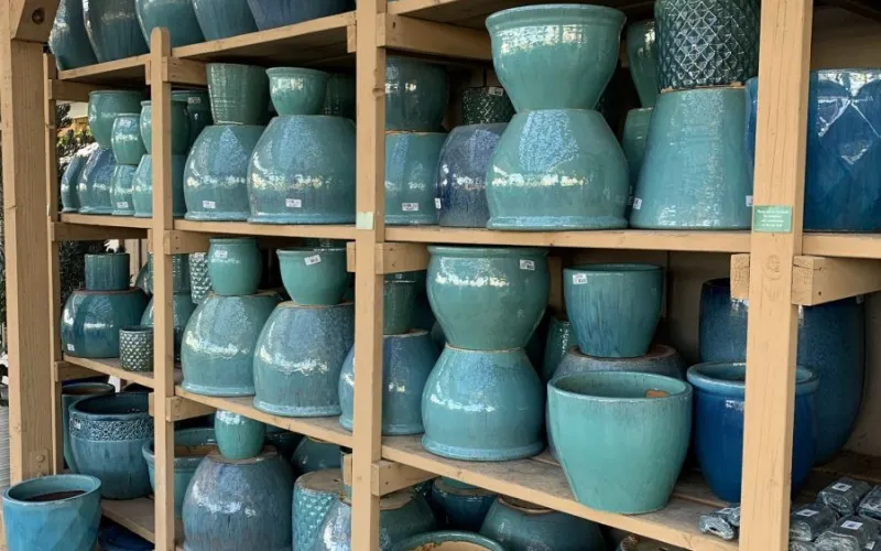 a bunch of blue planters that are sitting on a shelf