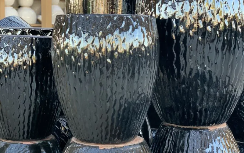 a group of metallic garden planters