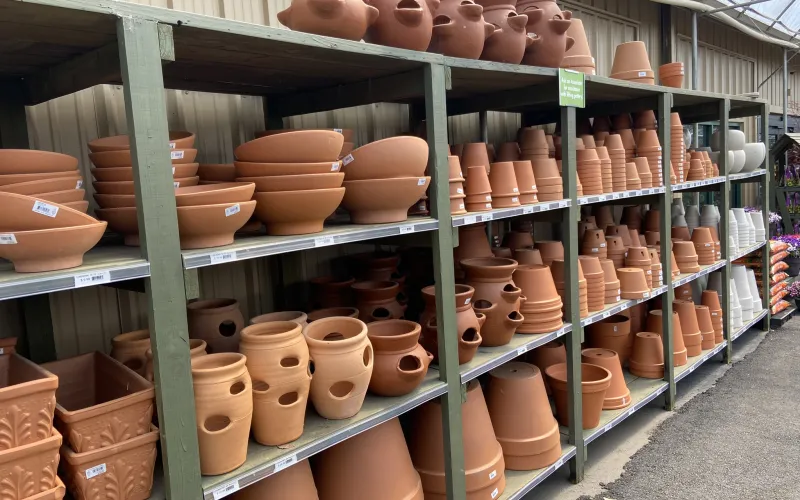 a shelf with many pots on it