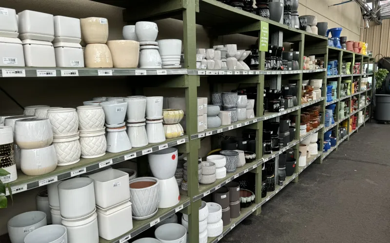 a room with shelves of white buckets and buckets