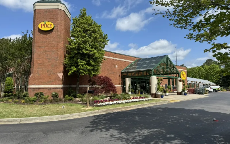 a brick building with a green roof