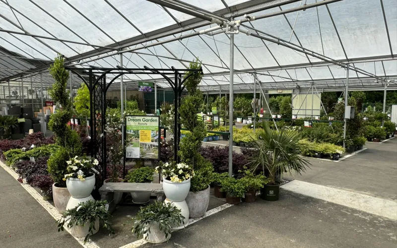 a greenhouse with plants and signs