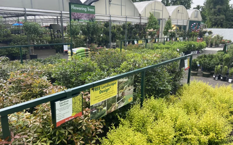 a green fence with a sign
