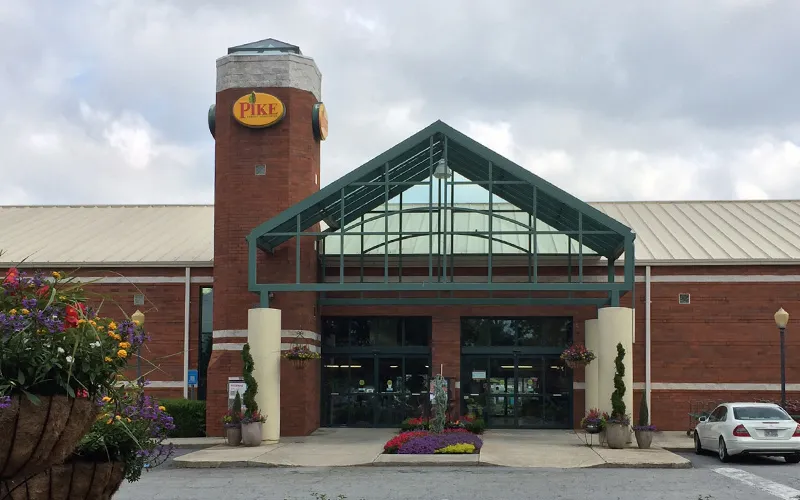 a building with a clock on the side of a road