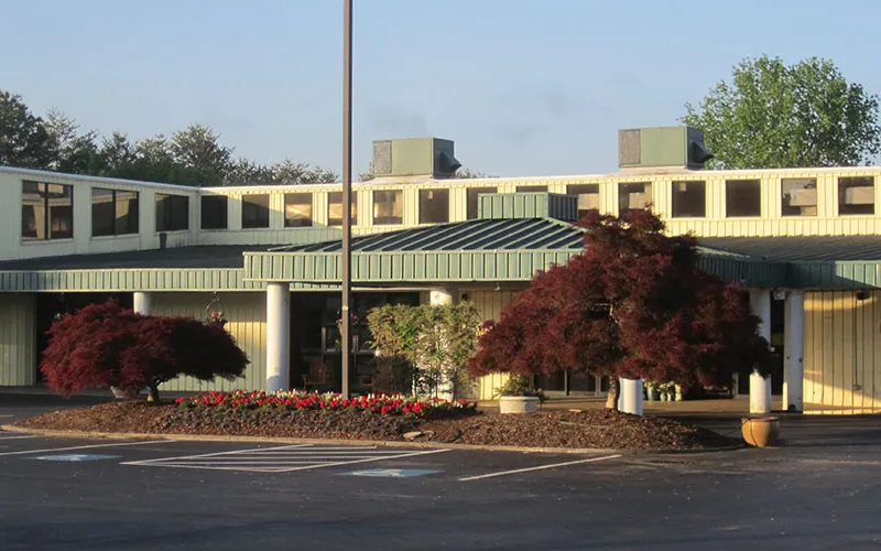 a building that has a sign on the side of a road