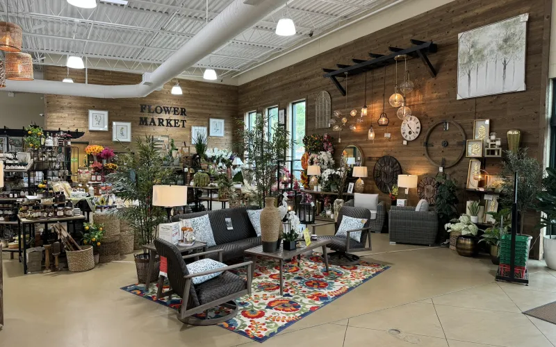a large room with a rug and chairs