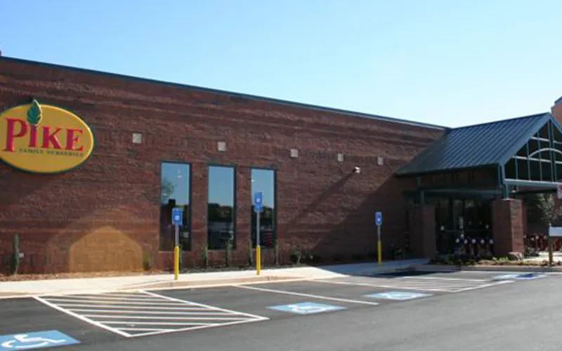 a building that has a sign on the side of a road