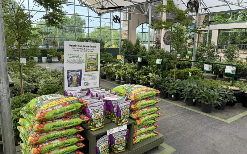 a greenhouse with plants and signs