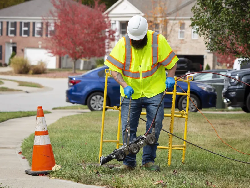 Man using equipment for sewage inspection and cross bore mitigation