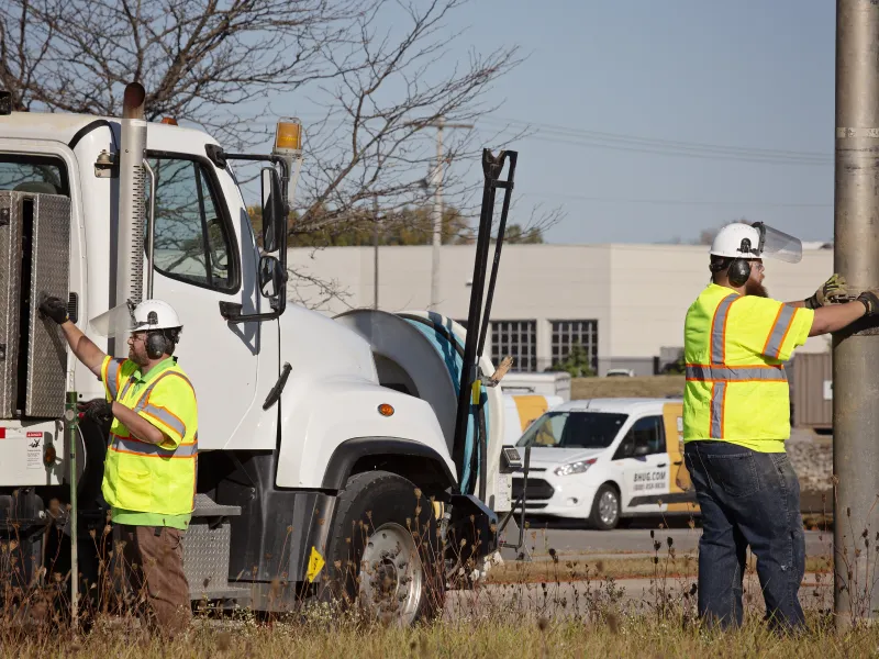 Two men from Blood Hound performing sub-surface utility engineering with truck