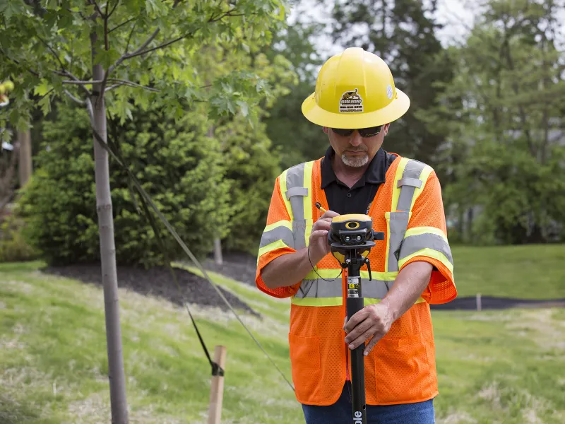 Man using utility mapping equipment to locate underground utilities