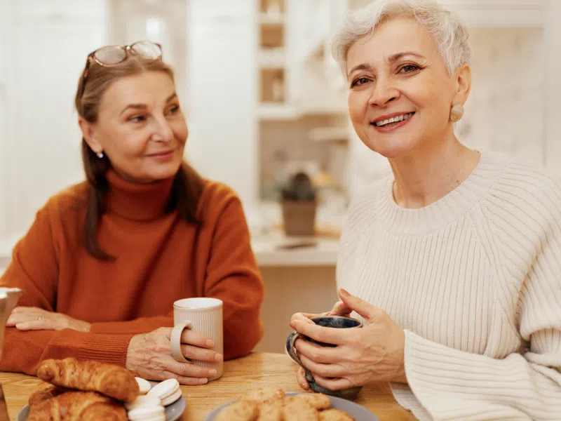 Two caregivers talking together in a support setting