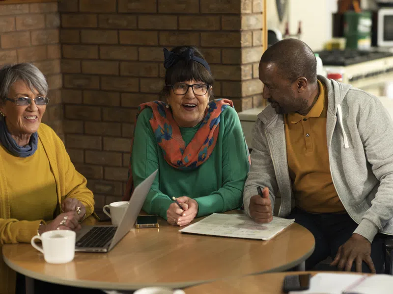 Caregivers talking together at a small workshop table