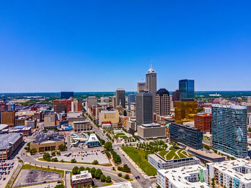 Aerial view of Indianapolis downtown skyline with modern skyscrapers and clear blue sky on a sunny day