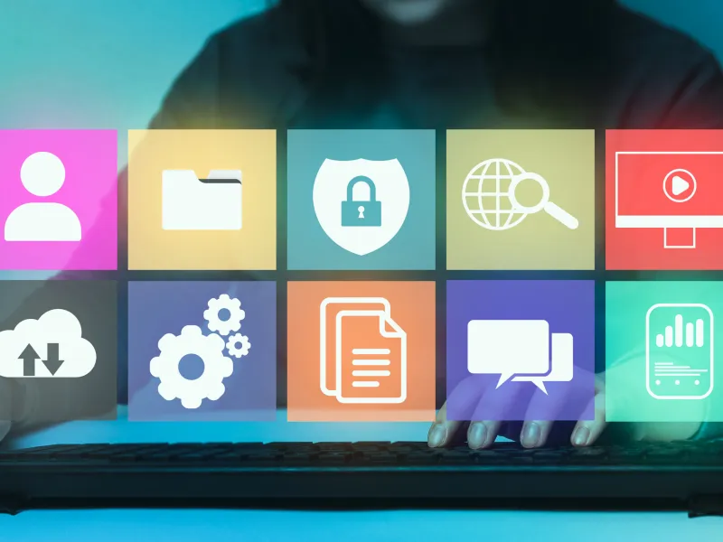 Person interacting with colorful icons on a touchscreen, showing digital and tech themes.
