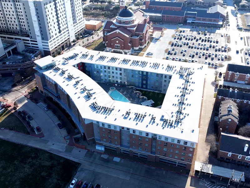 Aerial view of TPO flat roof installation on The Stack Apartments student housing complex in College Station Texas