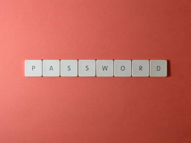 White keyboard keys spelling PASSWORD on a coral red background symbolizing security and access.