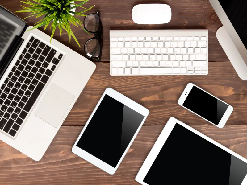 a table with several laptops and a keyboard