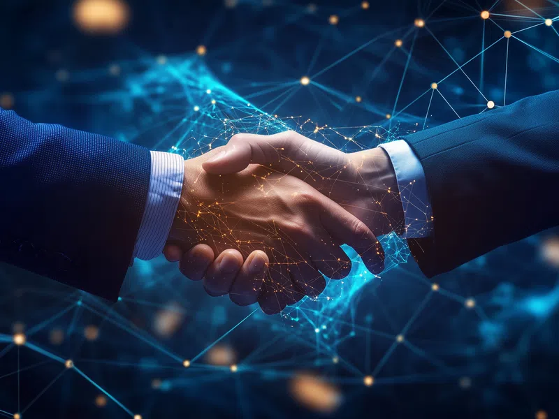 Two business professionals shaking hands surrounded by digital network connections and glowing data points.