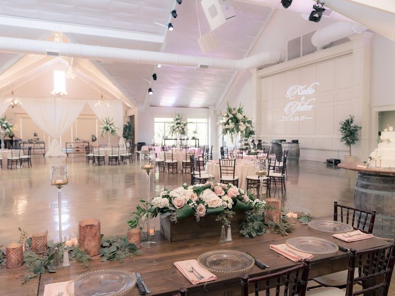 a living room filled with furniture and vase of flowers on a table