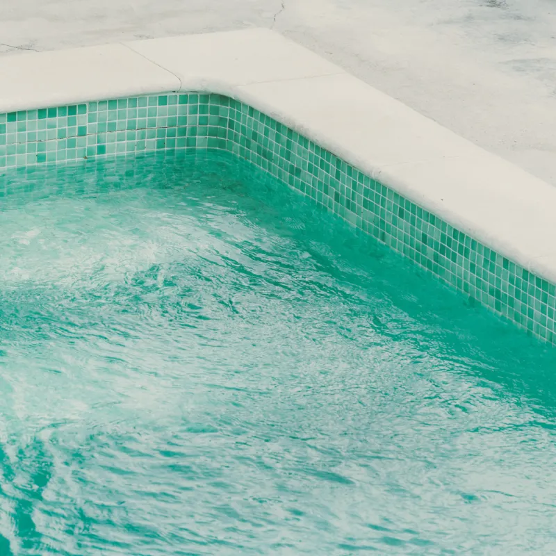 a pool with a white wall