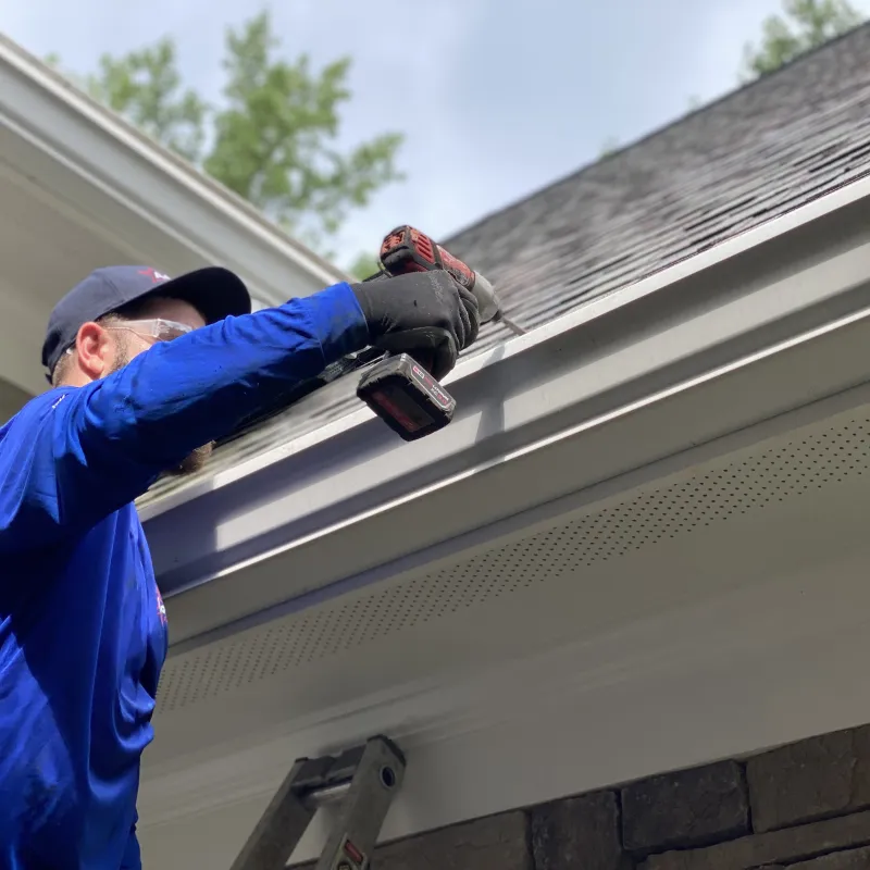 a man repairing a section of gutter