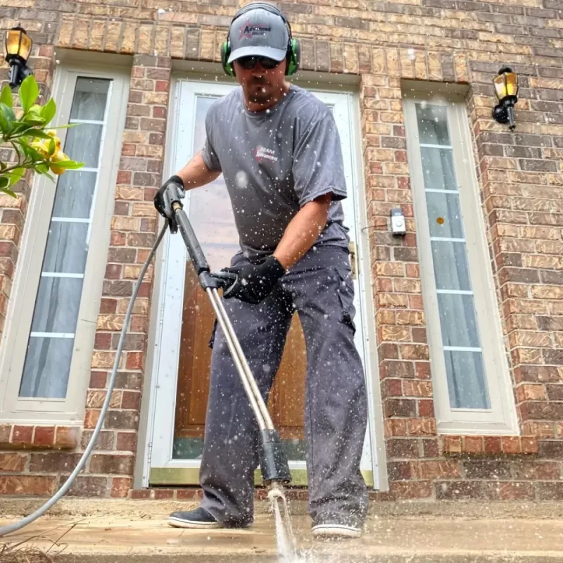 a man washing a porch